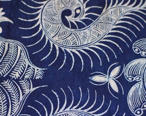 Close-up of hand-drawn wax lines on indigo cloth